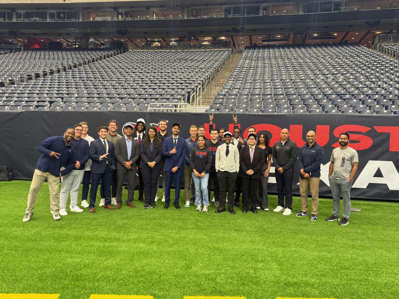 Student teams with the Texans front office, analytics staff and coaches on the field at NRG Stadium