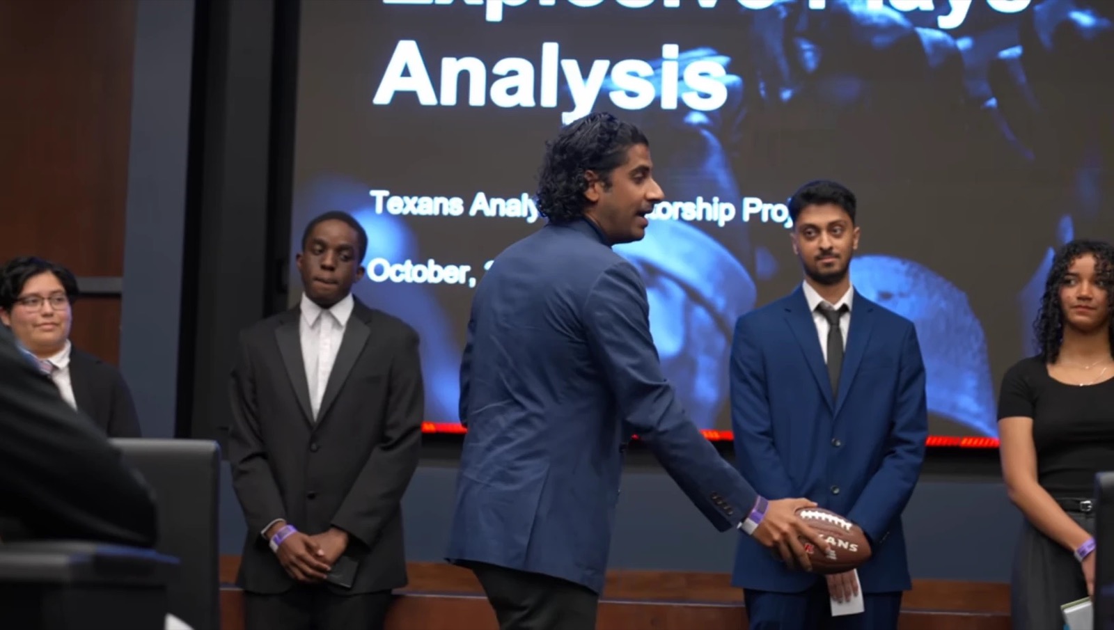 Avi presenting with Team A on stage